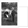 Woman in men's' clothes with a stroller at a baby shower, ca. 1924 by Anonymous