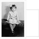 Young girl sits on a sofa, ca. 1933 by Anonymous