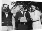 Boy with his parents on his 8th grade graduation, ca. 1940 by Anonymous