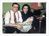 Young couple holding baby boy in christening gown, ca. 1952 by Anonymous