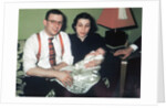 Young couple holding baby boy in christening gown, ca. 1952 by Anonymous