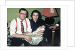 Young couple holding baby boy in christening gown, ca. 1952 by Anonymous