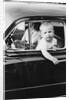 Young boy hangs out of driver's side car window, ca. 1954 by Anonymous