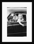 Young boy hangs out of driver's side car window, ca. 1954 by Anonymous