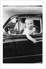 Young boy hangs out of driver's side car window, ca. 1954 by Anonymous