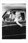 Young boy hangs out of driver's side car window, ca. 1954 by Anonymous