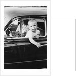 Young boy hangs out of driver's side car window, ca. 1954 by Anonymous