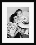 Baby boy hugging mother at dinner time, ca. 1953 by Anonymous