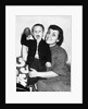 Little boy holding football with his mother, ca. 1955 by Anonymous