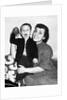 Little boy holding football with his mother, ca. 1955 by Anonymous