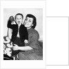Little boy holding football with his mother, ca. 1955 by Anonymous
