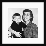 Mother holding son playing peek-a-boo, ca. 1955 by Anonymous
