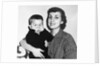 Mother holding son playing peek-a-boo, ca. 1955 by Anonymous