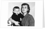 Mother holding son playing peek-a-boo, ca. 1955 by Anonymous