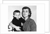 Mother holding son playing peek-a-boo, ca. 1955 by Anonymous
