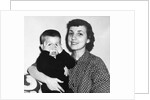 Mother holding son playing peek-a-boo, ca. 1955 by Anonymous