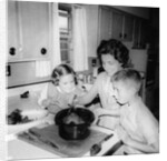 Mom prepares dinner with the kids watching, ca. 1962 by Anonymous