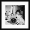 Mom prepares dinner with the kids watching, ca. 1962 by Anonymous