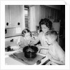 Mom prepares dinner with the kids watching, ca. 1962 by Anonymous