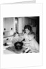 Mom prepares dinner with the kids watching, ca. 1962 by Anonymous
