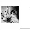 Mom prepares dinner with the kids watching, ca. 1962 by Anonymous