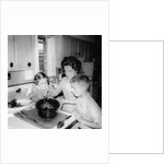 Mom prepares dinner with the kids watching, ca. 1962 by Anonymous