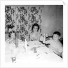 Mother with children at the dinner table, ca. 1962 by Anonymous