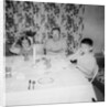 Father with children at the dinner table, ca. 1962 by Anonymous