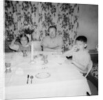 Father with children at the dinner table, ca. 1962 by Anonymous