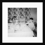 Father with children at the dinner table, ca. 1962 by Anonymous