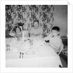 Father with children at the dinner table, ca. 1962 by Anonymous