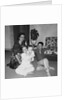 Mother with son and daughter in living room, ca. 1960 by Anonymous