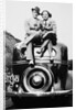 Couple proudly sits on their new car, ca. 1935 by Anonymous