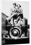 Couple proudly sits on their new car, ca. 1935 by Anonymous