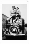 Couple proudly sits on their new car, ca. 1935 by Anonymous