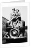 Couple proudly sits on their new car, ca. 1935 by Anonymous