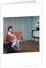 Young girl rides her new tricycle in the house, ca. 1967 by Anonymous