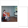 Young girl rides her new tricycle in the house, ca. 1967 by Anonymous
