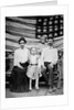 Family pose in front of American Flag, ca. 1898 by Anonymous