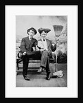 Two young men on a bench with a broom, ca. 1900 by Anonymous