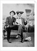 Two young men on a bench with a broom, ca. 1900 by Anonymous