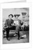 Two young men on a bench with a broom, ca. 1900 by Anonymous
