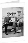 Two young men on a bench with a broom, ca. 1900 by Anonymous