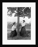 Two women chase each other around a tree, ca. 1910 by Anonymous