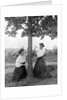 Two women chase each other around a tree, ca. 1910 by Anonymous