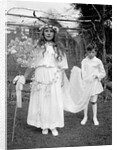 Young girl and attending young boy, ca. 1900. by Anonymous