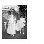 Young girl and attending young boy, ca. 1900. by Anonymous