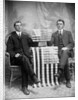 Two men pose with American flags, ca. 1895. by Anonymous