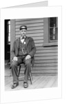Station master sits at the train depot, ca. 1900. by Anonymous