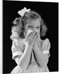 1940s little blond girl ribbon in hair holding tissue to nose sneezing by Anonymous